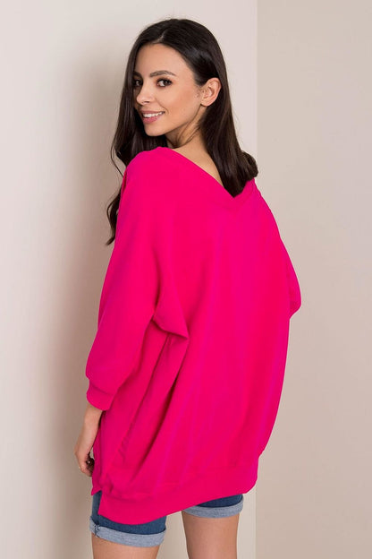 Fashionable Loose Fit Rue Paris Sweatshirt With Heart Neckline in radiant pink, model captured smiling while showcasing an elegant casual look, constructed from a soft cotton-spandex mix.