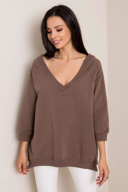 Sophisticated Loose Fit Rue Paris Sweatshirt With Heart Neckline in warm brown, model smiling while wearing stylishly, designed for comfort with 90% cotton and 10% spandex.