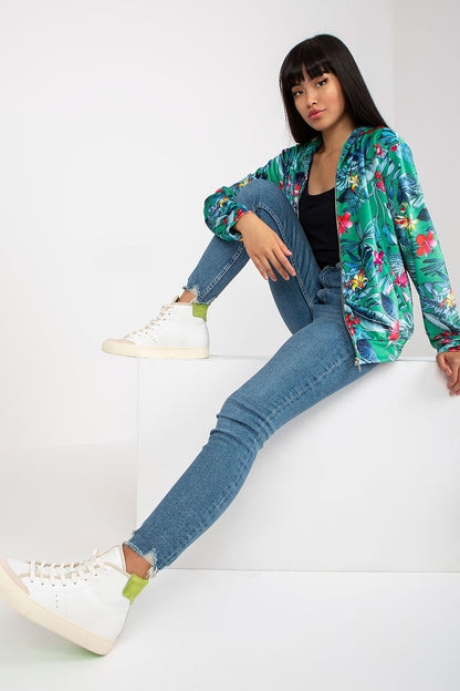 Luxury Rue Paris Women's Hooded Sweatshirt with Zip and Side Pockets – Elegant Long Sleeves, model wearing a vibrant floral hoodie paired with denim jeans and stylish sneakers.