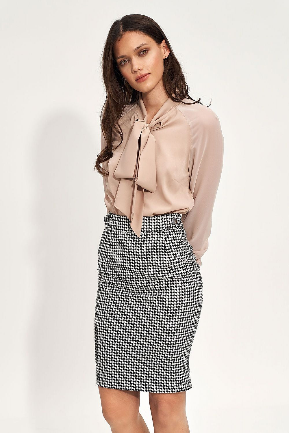 Elegant High Waist Peplum Pencil Skirt by Nife, styled with a soft beige blouse featuring a bow tie, showcasing sophistication and versatility for office or evening wear.