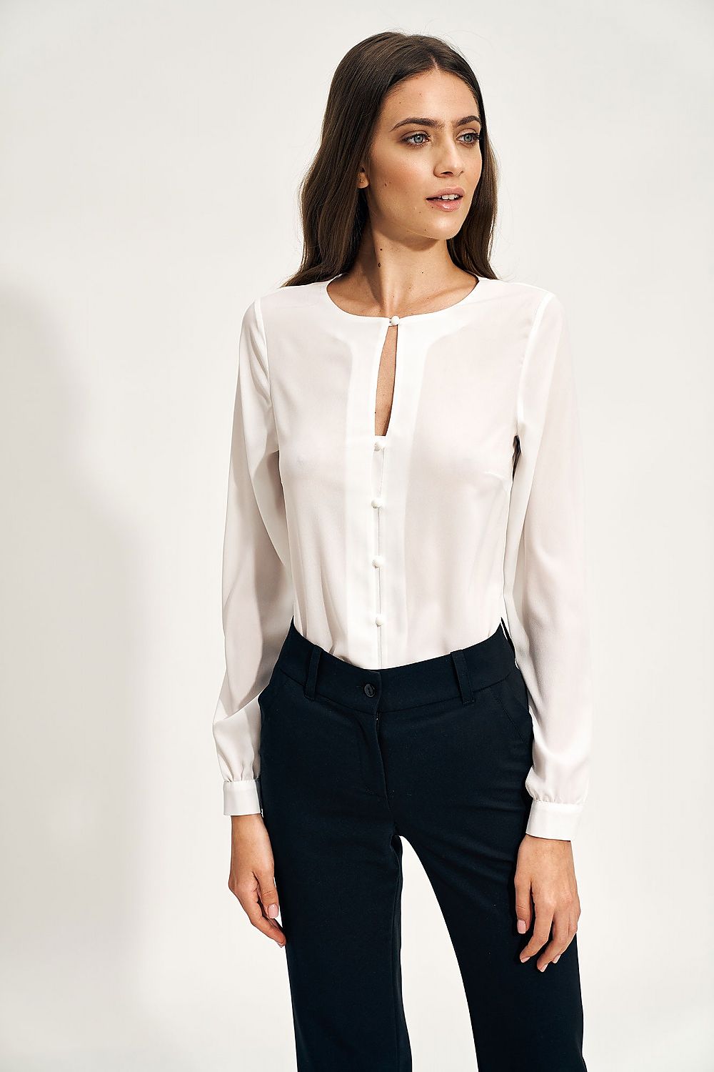 Elegant Nife Teardrop Long Sleeve Shirt with Unique Neckline, perfect for sophisticated office styling, featuring a refined buttoned design and styled with tailored black trousers.
