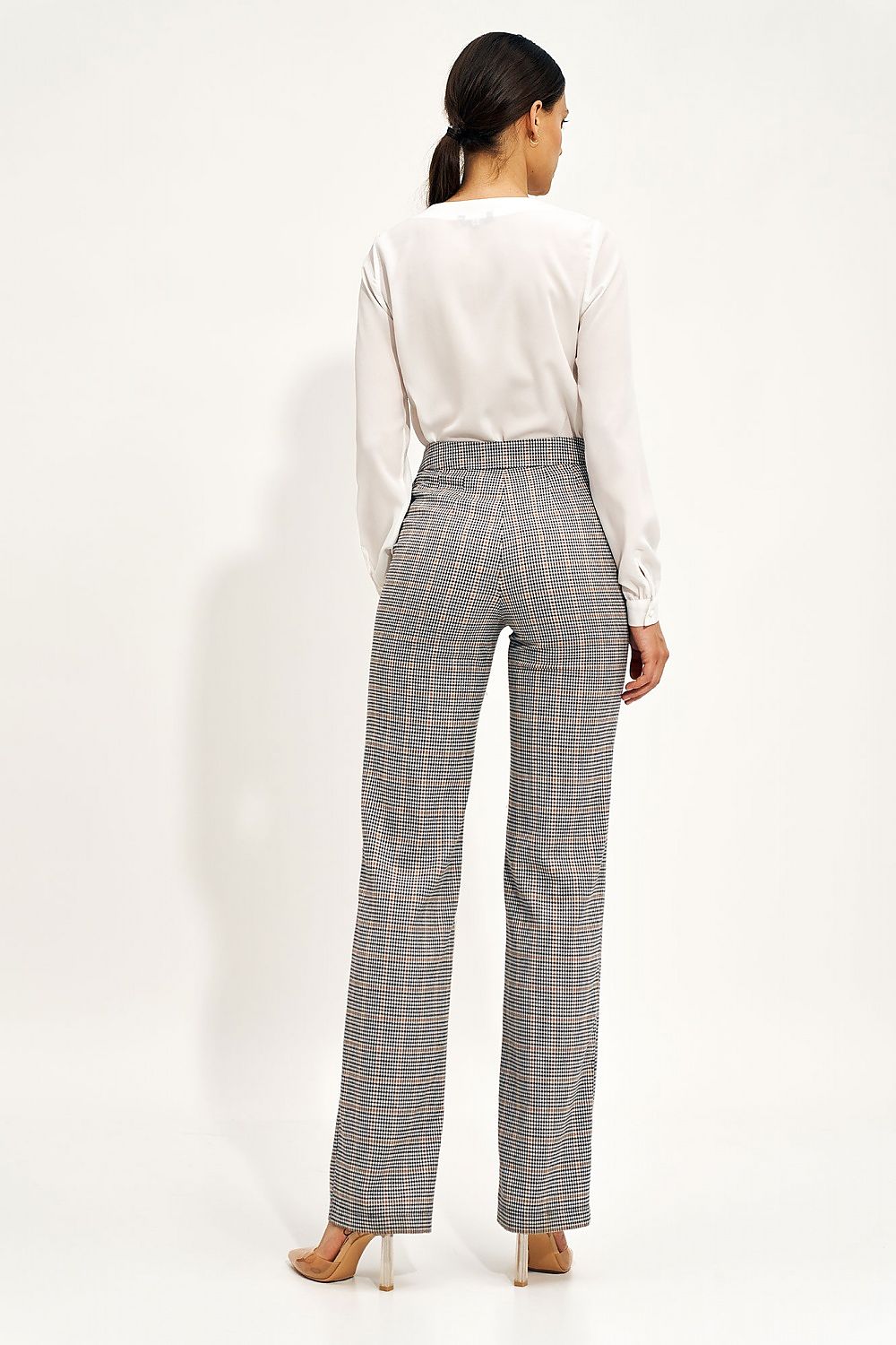 Back view of the Nife Teardrop Long Sleeve Shirt with Unique Neckline for Elegant Office Styling, paired with stylish checkered trousers, highlighting the shirt's versatility and elegant silhouette.