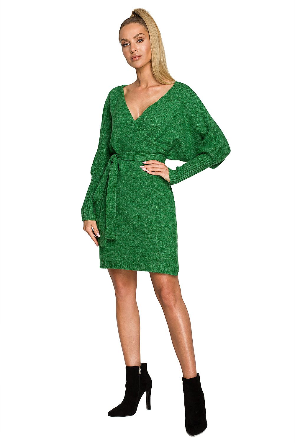 Elegant Mini Sweater Dress by Moe featuring a deep overlap neckline and wide sleeves, showcased in vibrant green colour, styled with ankle boots.