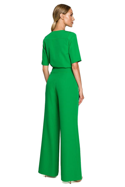 Rear view of the Elegant Wide Leg Trouser Suit with Elbow-Length Sleeves, featuring pockets and a sleek design in vibrant green, designed by Moe.