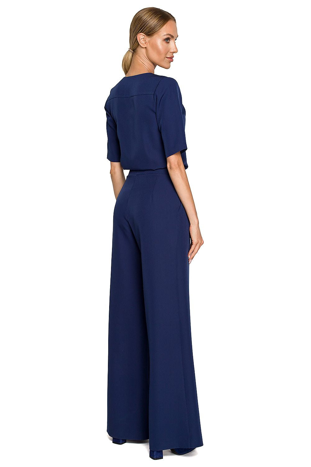 Elegant Wide Leg Trouser Suit with Elbow-Length Sleeves and Pockets - Designed by Moe, displaying a model from the back in a navy blue trouser suit, showcasing its chic style.