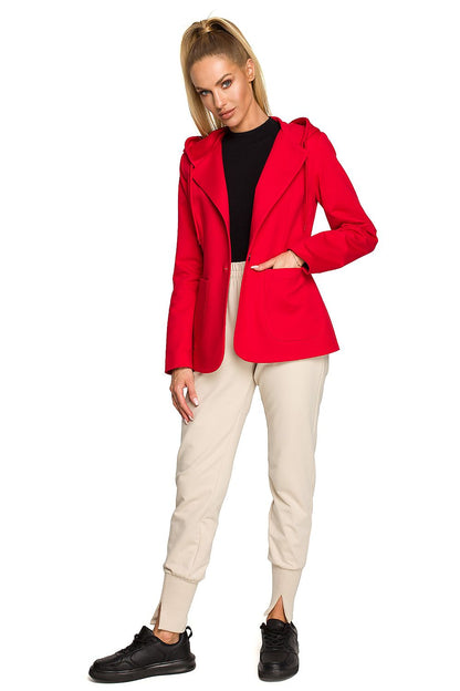 Full view of the Moe Luxe Knitted Fabric Jacket with Hood and Pockets in red, styled with beige trousers, embodying modern elegance and comfort.