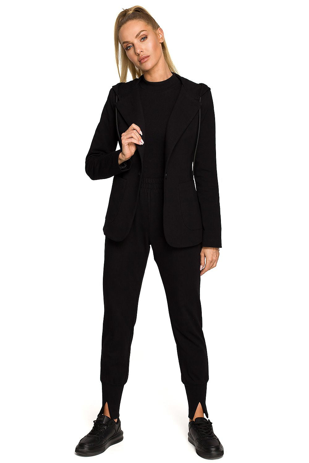 Moe Luxe Knitted Fabric Jacket with Hood and Pockets, worn by a model in all-black attire, featuring a stylish blend of comfort and sophistication.