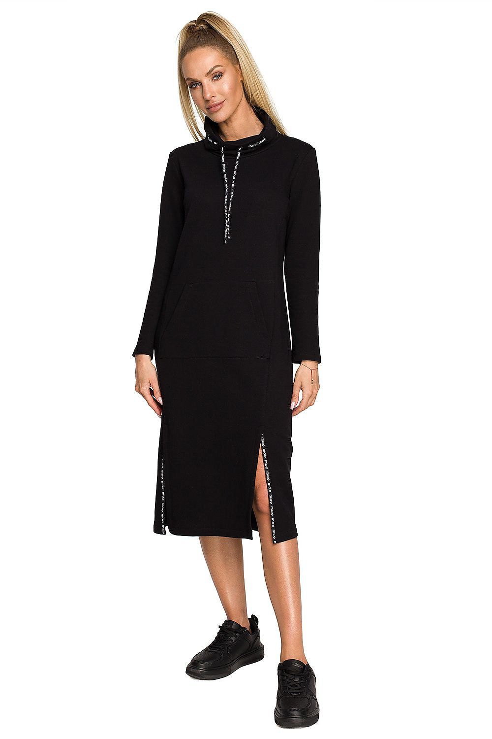 Moe Daydress: Elegant Midi Dress featuring a comfortable knit fabric, showcased on a model standing in a black version of the dress with a high collar and logo detailing.