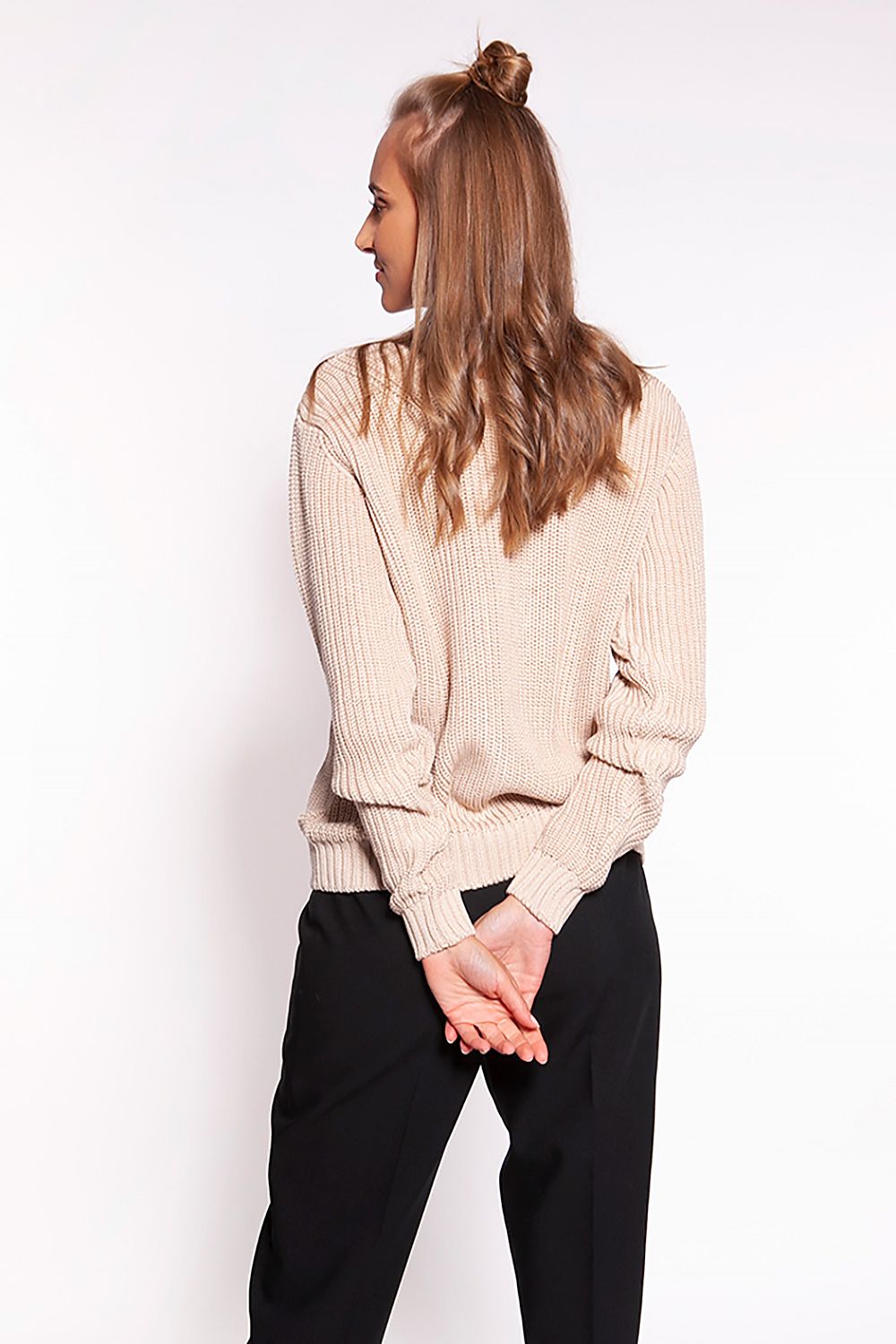 Luxurious Minimalist Ribbed Knit Jumper with Deep Heart Neckline by MKM, back view of the beige sweater emphasizing its ribbed texture, styled alongside tailored black trousers.