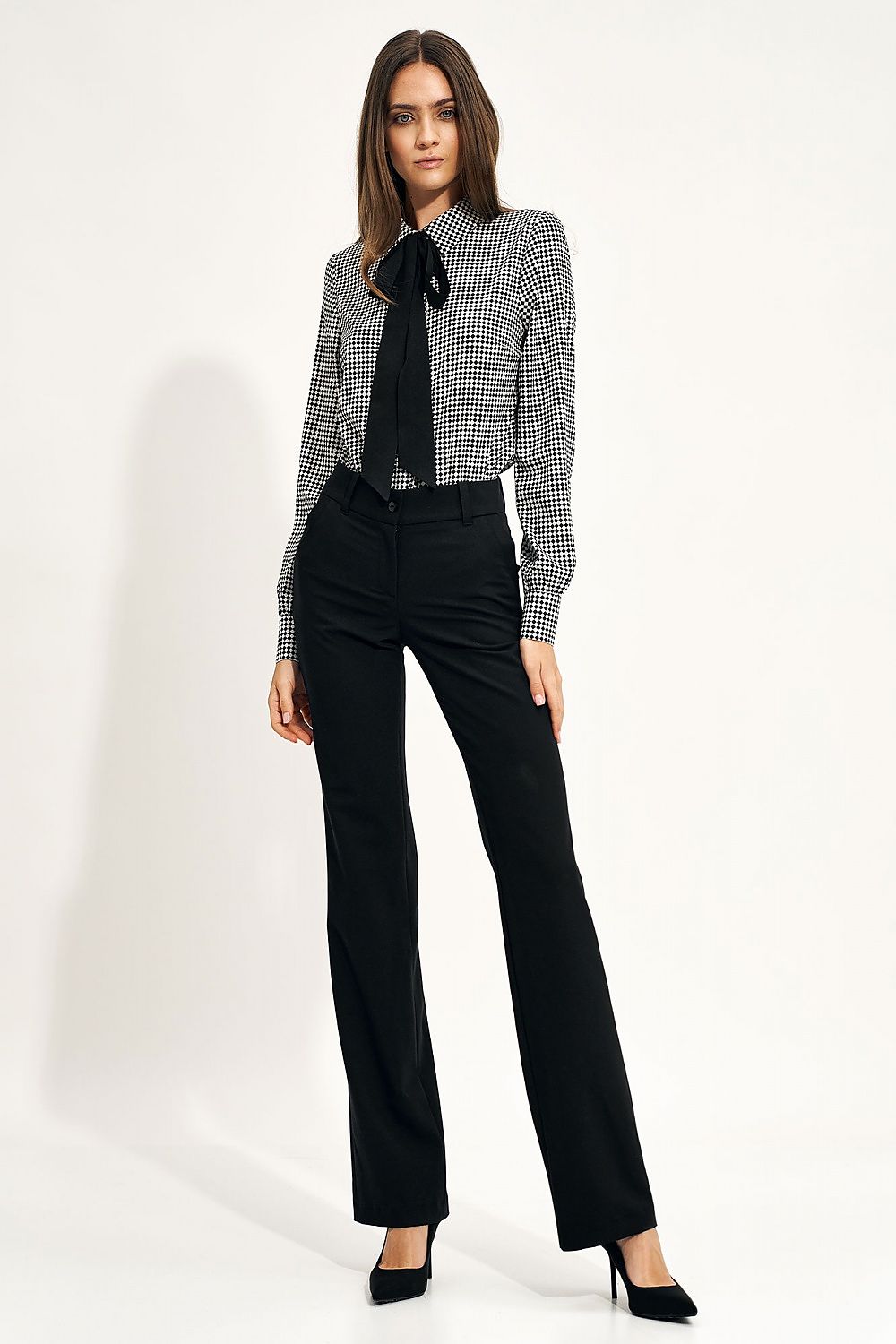 Model wearing the Elegant Long Sleeve Bow Shirt by Nife, paired with tailored black pants, displaying a chic office look with a fashionable print.