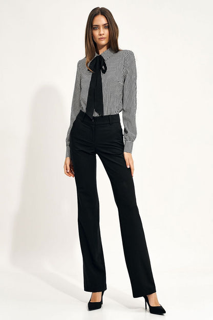 Model wearing the Elegant Long Sleeve Bow Shirt by Nife, paired with tailored black pants, displaying a chic office look with a fashionable print.