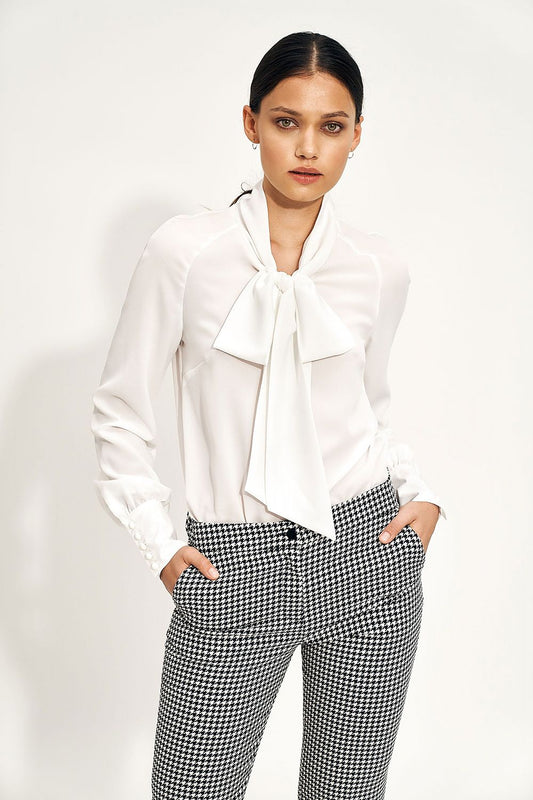 Elegant Ecru Blouse With Decorative Neck Tie and Wide Cuff Sleeves by Nife, styled with sophisticated houndstooth patterned trousers for a luxurious look.