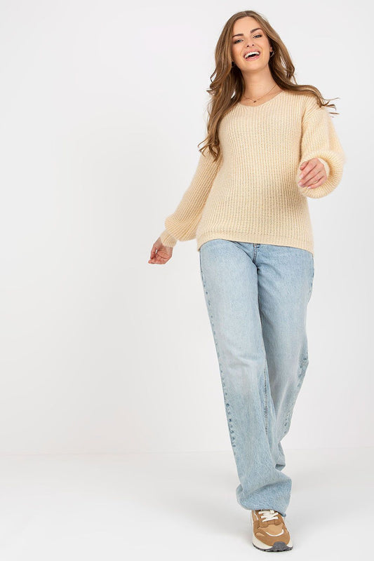 Chic Women's Heart Neckline Jumper by Och Bella, displayed elegantly on a model. The luxurious long sleeve wool blend sweater features a soft, beige texture, paired with stylishly relaxed blue denim jeans, exuding sophistication and comfort.