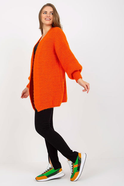 Fluffy Unbuttoned Long Sleeve Cardigan by Och Bella, showcasing its vibrant orange colour and soft texture, styled with black leggings and sporty shoes, perfect for a chic yet comfortable look.