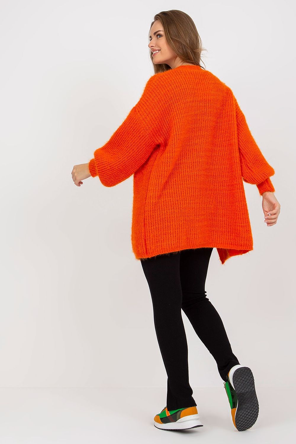 Back view of the Fluffy Unbuttoned Long Sleeve Cardigan by Och Bella, highlighting its luxurious orange knit and relaxed fit, paired elegantly with black leggings for a stylish ensemble.