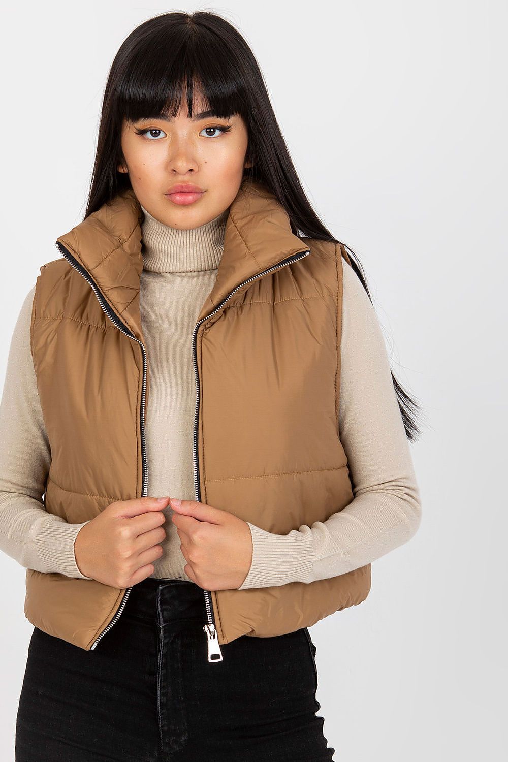 Captivating view of the Och Bella Women's Insulated Quilted Vest - Short Zippered Nylon Gilet, worn by a model, emphasising the chic brown hue and contemporary style suitable for luxury fashion.