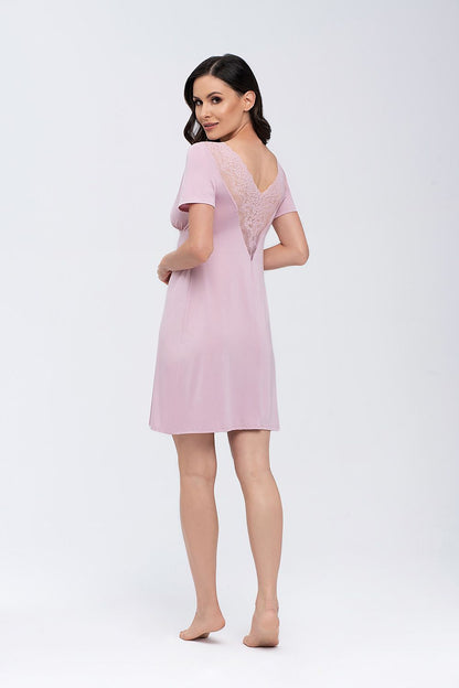 Babella Nightshirt, a luxurious piece adorned with lace detailing at the back, model displayed in soft pink, highlighting the graceful silhouette and quality fabric.