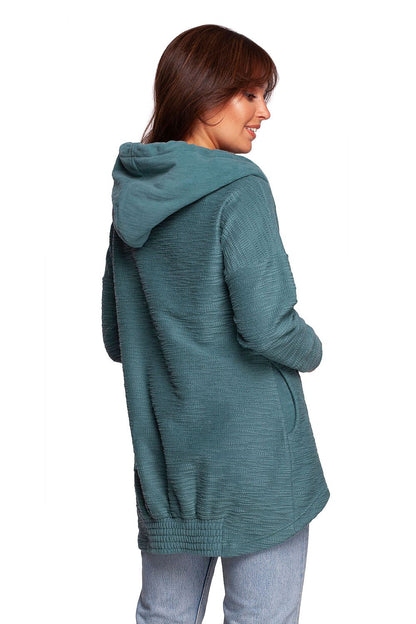 BeWear Oversized Cotton Blend Hooded Sweatshirt Tunic for Comfortable Cold Weather, rear view of the model highlighting the stylish oversized fit and cozy hood in a luxurious teal fabric.