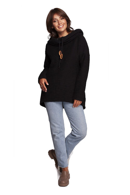 BeWear Oversized Cotton Blend Hooded Sweatshirt Tunic in black, featuring a cozy hood and chic oversized cut, styled with denim for an elegant cold-weather look.