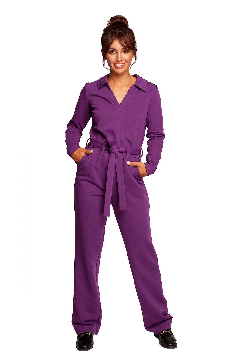 Chic BeWear suit with wide legs, V neckline, and comfortable belt in vibrant purple, perfect for work and theatre. Model showcasing the front view confidently.