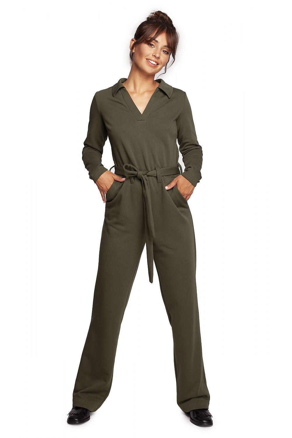 Chic BeWear suit with wide legs, V neckline, and a comfortable belt in sophisticated olive green, worn by a model for work and theatre events.