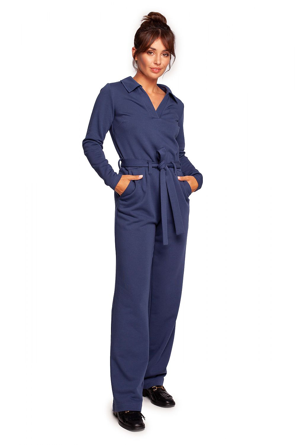 Chic BeWear suit with wide legs, V neckline, and comfortable belt in deep navy, styled for a fashionable look suitable for both work and theatre.