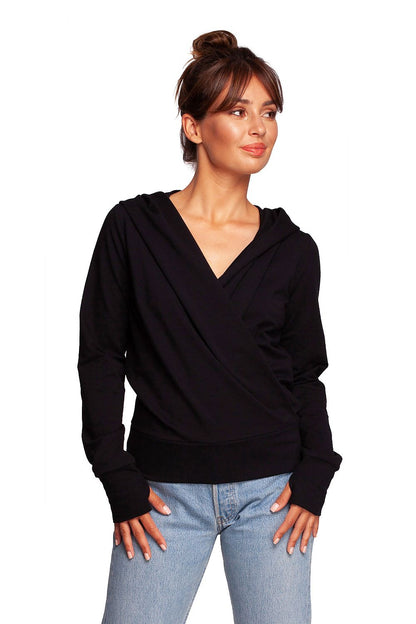 BeWear Elegant Sweatshirt With Hood, made from 92% cotton and featuring thumb cutouts. This image showcases a model wearing a sleek black sweatshirt with a unique envelope cut, presenting a stylish and sophisticated look.