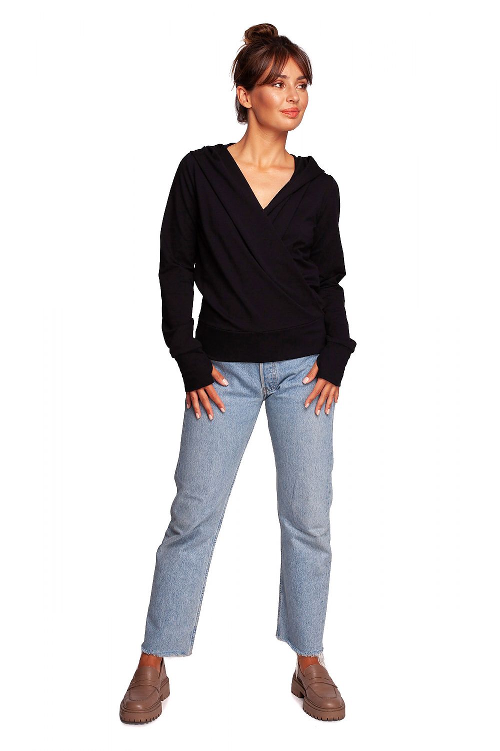 BeWear Elegant Sweatshirt With Hood, designed with a slim fit and thumb cutouts, displayed on a model in a chic black sweatshirt. The crossover front adds a touch of unique elegance, complemented by casual denim.