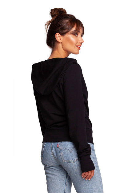 BeWear Elegant Sweatshirt With Hood, featuring thumb cutouts and a blend of 92% cotton. The model shows off the back of this refined black sweatshirt, emphasizing its luxurious style and attention to detail.