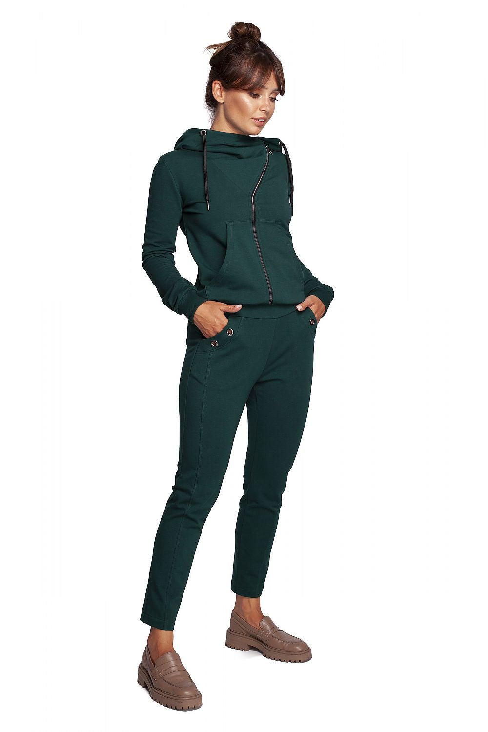 Model exhibiting BeWear Women's Elegant Trousers with Elastic Waistband and Stylish Side Pockets in an elegant green outfit, complemented by a stylish hoodie.