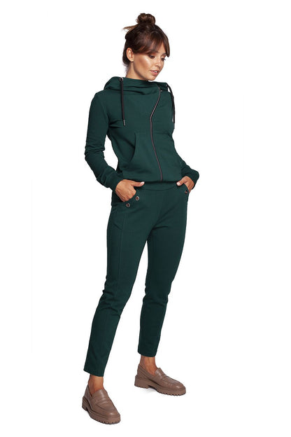 Model exhibiting BeWear Women's Elegant Trousers with Elastic Waistband and Stylish Side Pockets in an elegant green outfit, complemented by a stylish hoodie.