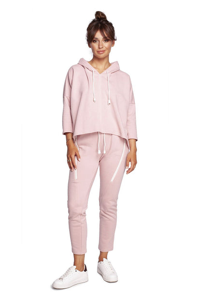 BeWear Loose-Fitting Trapeze Sweatshirt in Soft Knit with Hood and Faux Leather Accents, paired with sleek pink joggers for a luxurious athleisure ensemble.