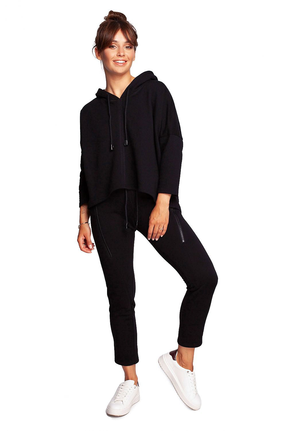 Full body view of the BeWear Loose-Fitting Trapeze Sweatshirt in Soft Knit with Hood and Faux Leather Accents, styled with black trousers for a sophisticated loungewear ensemble.