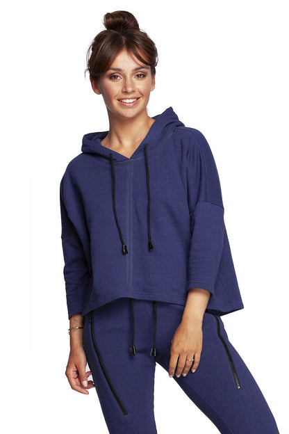 Elegant BeWear Loose-Fitting Trapeze Sweatshirt in Soft Knit with Hood and Faux Leather Accents, showcasing a model smiling with a chic bun hairstyle, perfect for a sophisticated casual look.