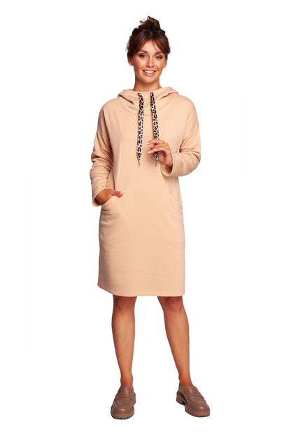 Chic BeWear Casual Daydress with High Collar adorned with leopard-print ribbons, presented in a soft blush hue. The dress features a cozy hood and convenient hidden pockets, ideal for a relaxed luxury ensemble.