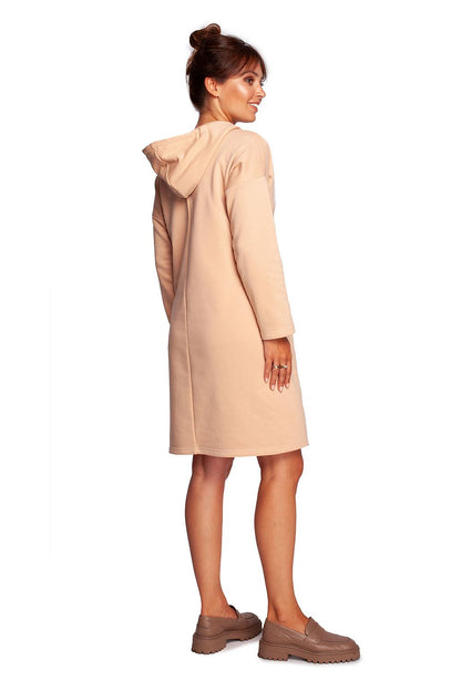 Sophisticated view of the BeWear Casual Daydress with High Collar, displayed in a light blush colour. The dress combines comfort and elegance, featuring a hood and hidden pockets, perfect for stylish everyday wear.