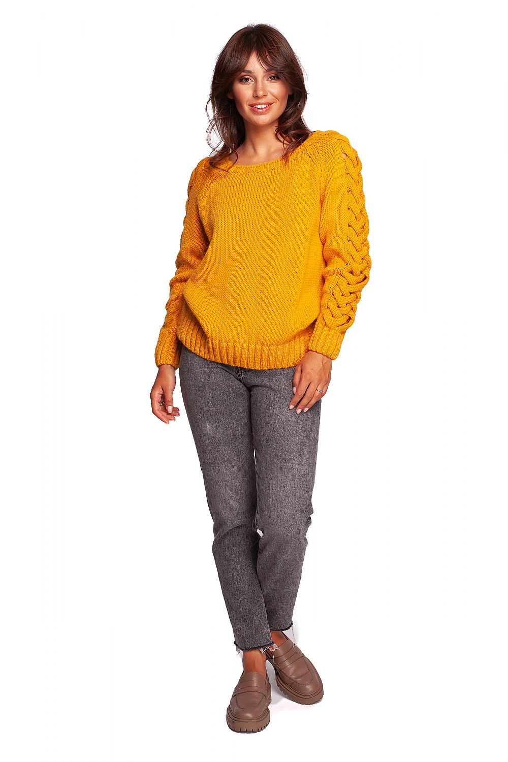 Luxury fitted jumper with shoulder revealing neckline and thick plaid sleeve weave, displayed on a model in a full-body view, styled with grey trousers and footwear for seasonal elegance.