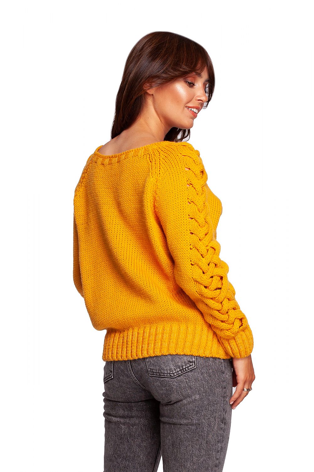 Luxury fitted jumper with shoulder revealing neckline and thick plaid sleeve weave, featuring a side profile of the model demonstrating the unique shoulder design and textured sleeves.