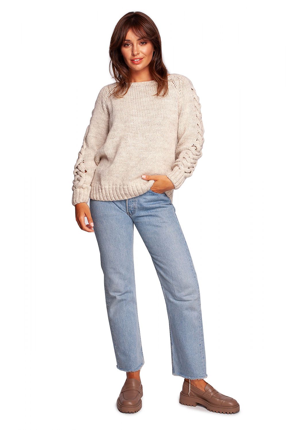 Luxury fitted jumper with shoulder revealing neckline and thick plaid sleeve weave, presented on a model in a stylish outfit of relaxed denim, embodying modern luxury and comfort.