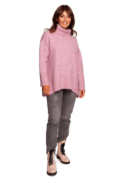 Luxury Turtleneck Knit Sweater with Ribbed Hem and Back Slit - Soft Warm Acrylic Blend, worn by a model in soft pink, featuring a stylish loose fit and elegant design.