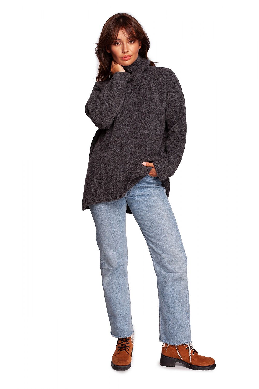 Luxury Turtleneck Knit Sweater with Ribbed Hem and Back Slit - Soft Warm Acrylic Blend, styled with casual chic by a model who pairs it with fashionable boots.