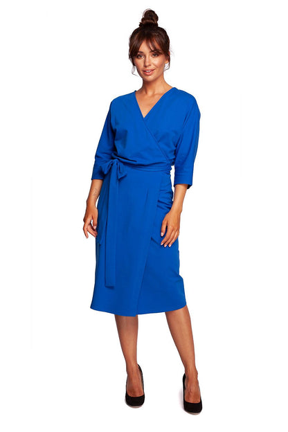 Elegant Cotton Knit Daydress with Envelope Cut and Batwing Sleeves by BeWear, showcasing a chic, fitted design in a vibrant blue colour, featuring a flattering wrap style and belt detail, worn by a model in an elegant pose.