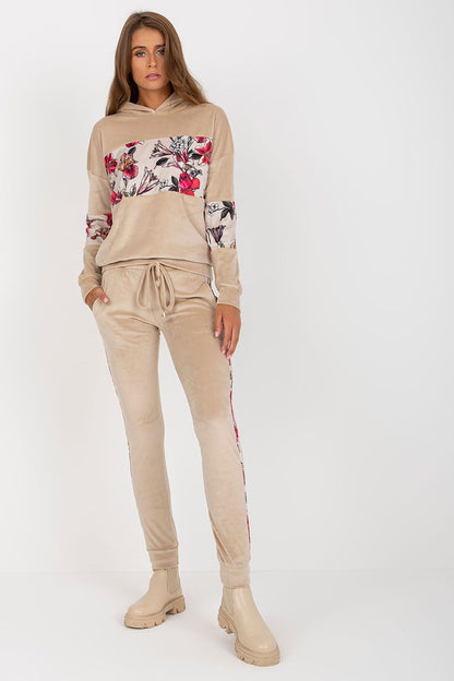 Luxurious Velour Travel Set featuring a stylish beige sweatshirt with floral prints and matching long pants, perfect for upscale travel occasions.
