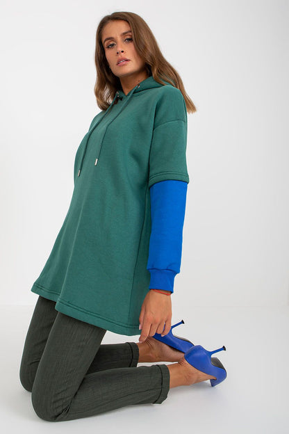 Luxury Women's Rue Paris Cotton Blend Sweatshirt with Hood, Extended Cut and Long Sleeves - Stylish model in a poised position with the elegant green hoodie and stylish blue sleeve details.
