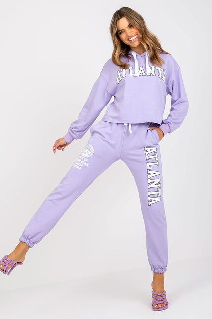 Luxury Ex Moda sweatshirt set featuring a hooded long sleeve top and high waist pants in lavender, styled with elegant footwear.