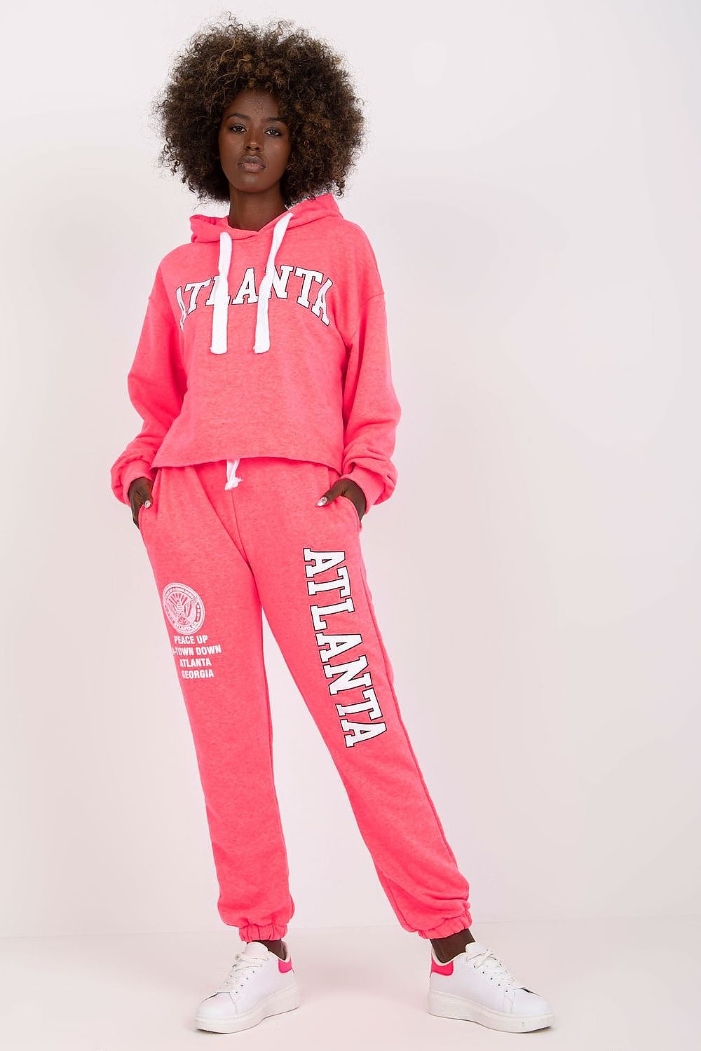 Luxury Ex Moda sweatshirt set in vibrant pink, showcasing a hooded long sleeve top and high waist pants, paired with fresh white sneakers.
