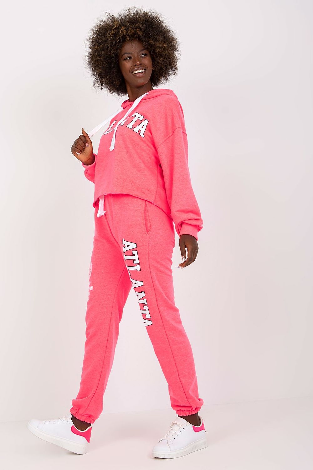 Luxury Ex Moda pink sweatshirt set with hooded long sleeve top and high waist pants, model posing confidently with an engaging smile.