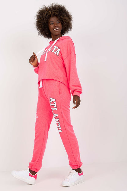 Luxury Ex Moda pink sweatshirt set with hooded long sleeve top and high waist pants, model posing confidently with an engaging smile.