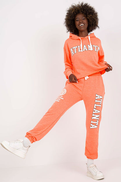 Luxury Ex Moda sweatshirt set in bright orange, featuring a hooded long sleeve top and high waist pants, model showcasing a fashionable ensemble.