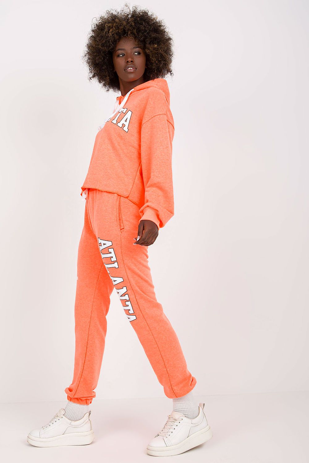Luxury Ex Moda Sweatshirt Set With Hooded Long Sleeve Top And High Waist Pants in striking coral, model posed elegantly to emphasise the stylish design and fit.